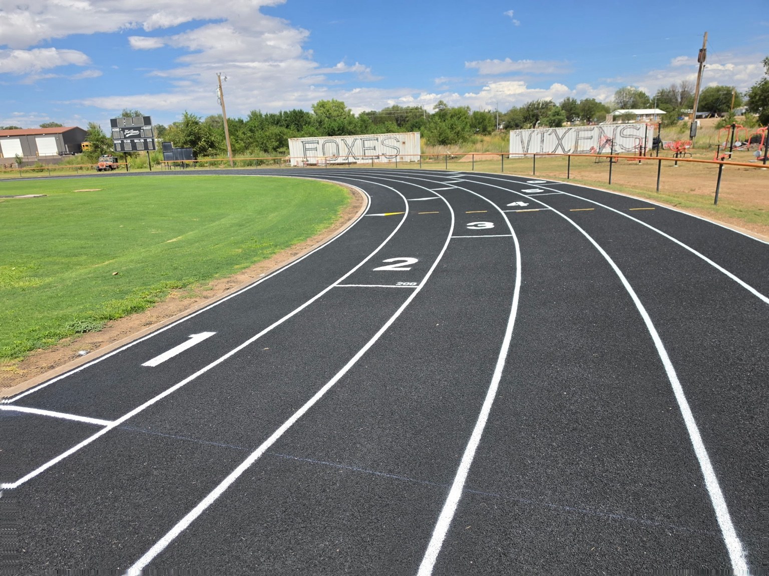 Curved running track lanes with fresh white striping